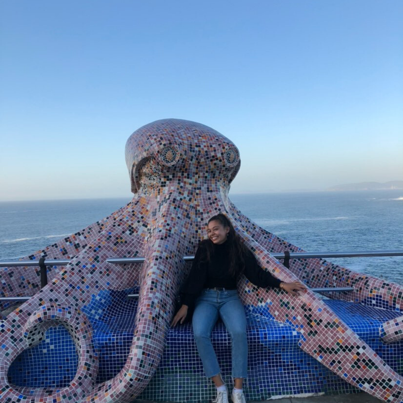 Fulbright recipient Sabrina Boutselis poses in front of Octopus sculpture in Spain